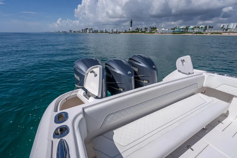 Slide: The Image of 2017 Intrepid 400 Center Console boat with triple Yamaha engines on open water. - 23