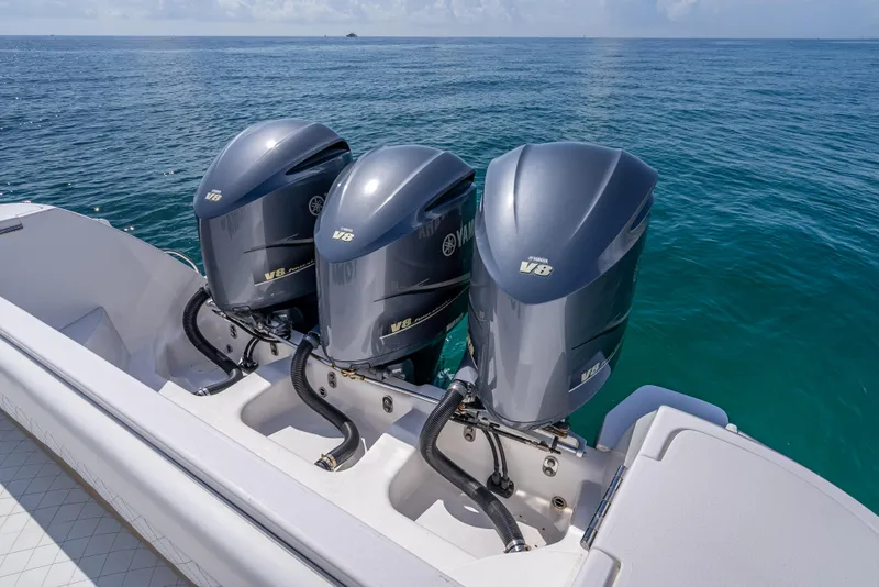 Slide: The Image of 2017 Intrepid 400 Center Console with triple Yamaha outboard engines on open water. - 25