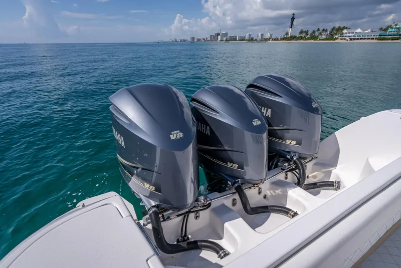 Slide: The Image of 2017 Intrepid 400 Center Console with triple Yamaha outboard engines on the ocean. - 27
