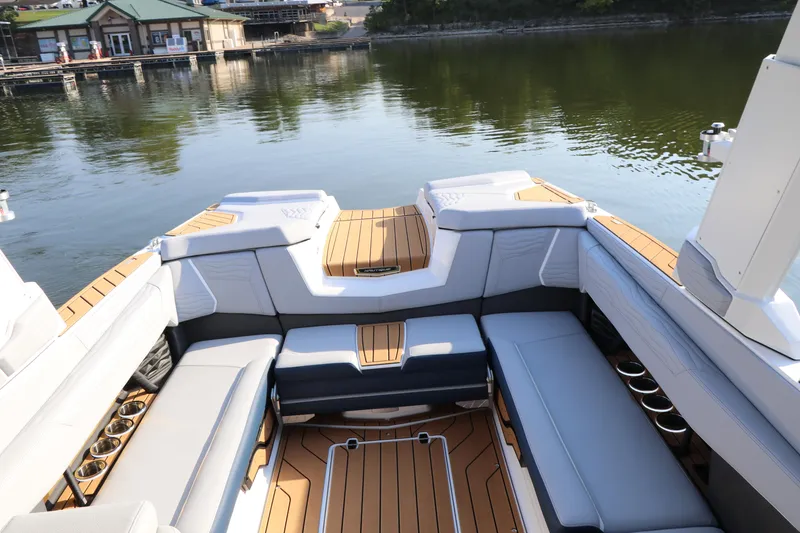Slide: The Image of 2025 Nautique G25 boat interior with luxurious seating and lake view. - 10