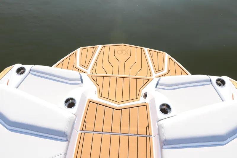 Slide: The Image of 2025 Nautique G25 boat deck with sleek design and teak flooring. - 12