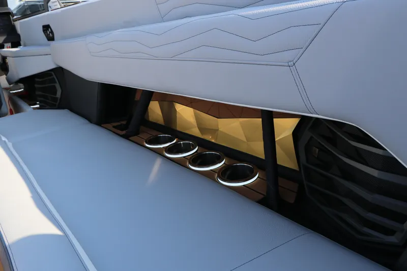 Slide: The Image of 2025 Nautique G25 boat interior with sleek seating and cup holders. - 14