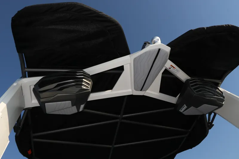 Slide: The Image of 2025 Nautique G25 boat speakers and canopy against clear blue sky. - 18