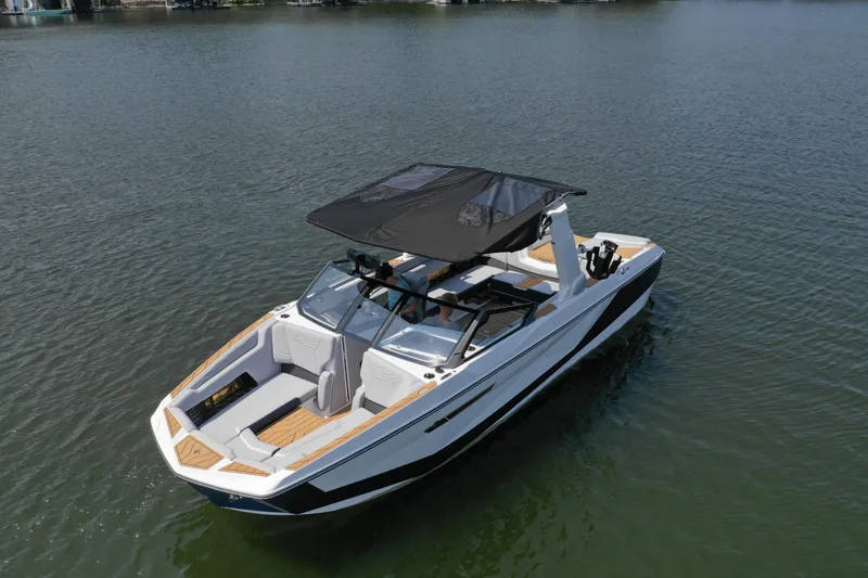 Slide: The Image of 2025 Nautique G25 boat on calm water, featuring sleek design and spacious seating. - 6