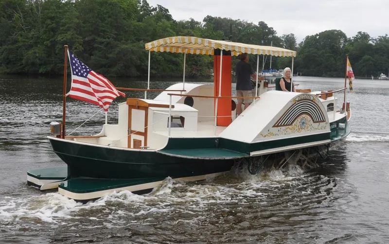 The Image of Custom 1987 sidewheel paddle yacht cruising on a river with American flag. - 0