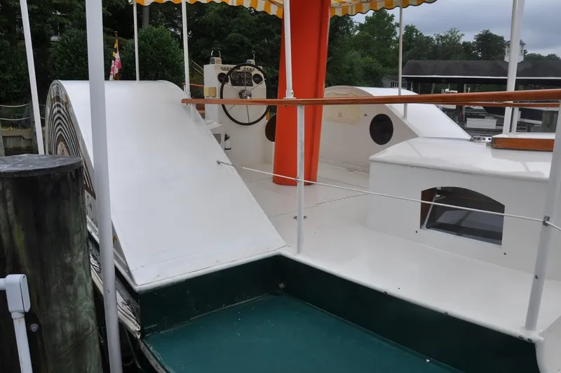 Slide: The Image of Custom 1987 sidewheel paddle yacht with canopy, docked at marina. - 10