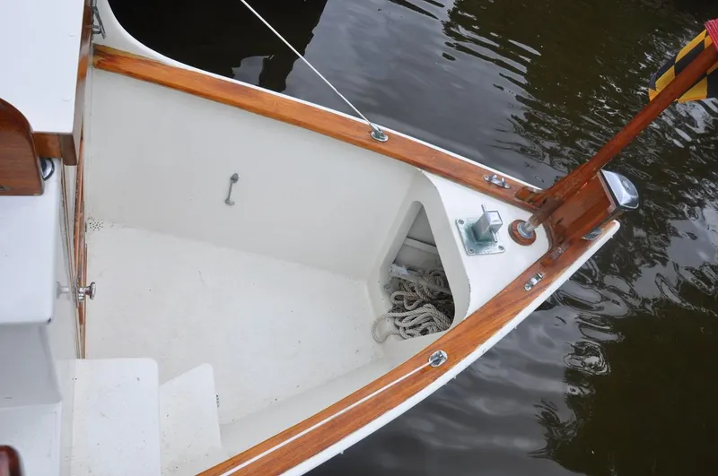 Slide: The Image of Custom 1987 Sidewheel Paddle Yacht with wooden trim and rope storage, docked on calm water. - 17