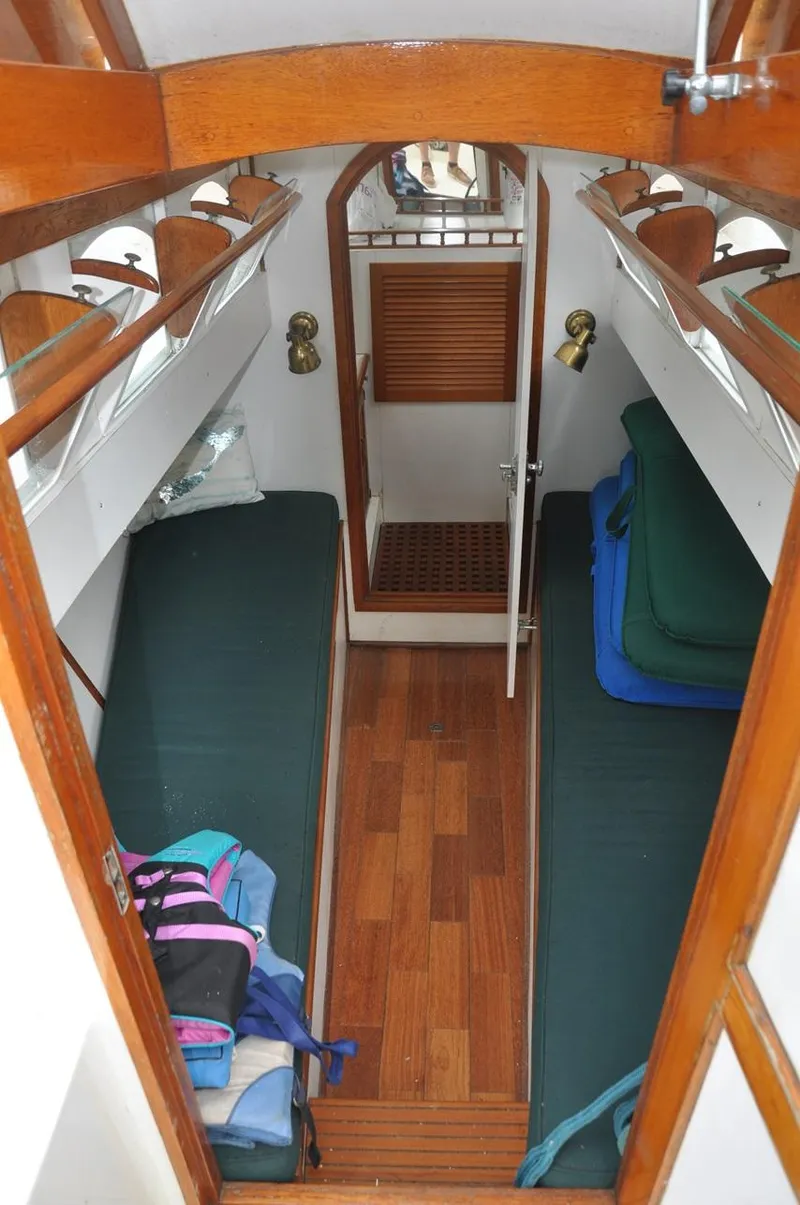 Slide: The Image of Interior of 1987 Custom Sidewheel Paddle Yacht with wooden flooring and green cushioned seating. - 19