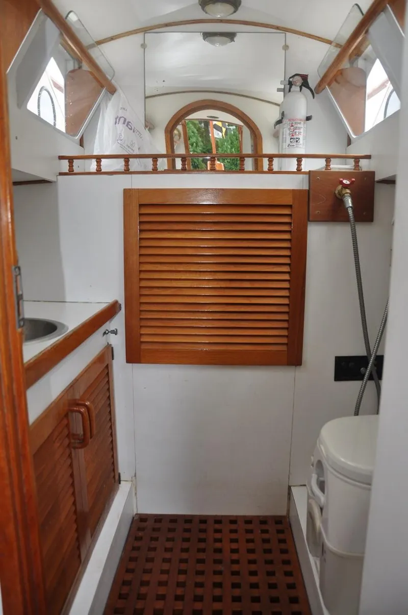 Slide: The Image of Interior of 1987 custom sidewheel paddle yacht bathroom with wooden accents and compact design. - 20