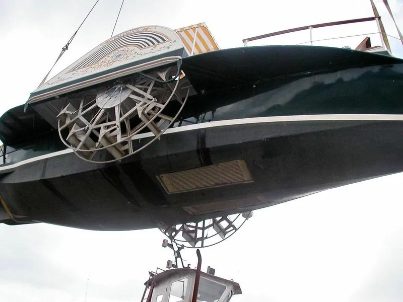 Slide: The Image of Custom 1987 sidewheel paddle yacht being lifted, showcasing intricate paddle mechanism. - 22