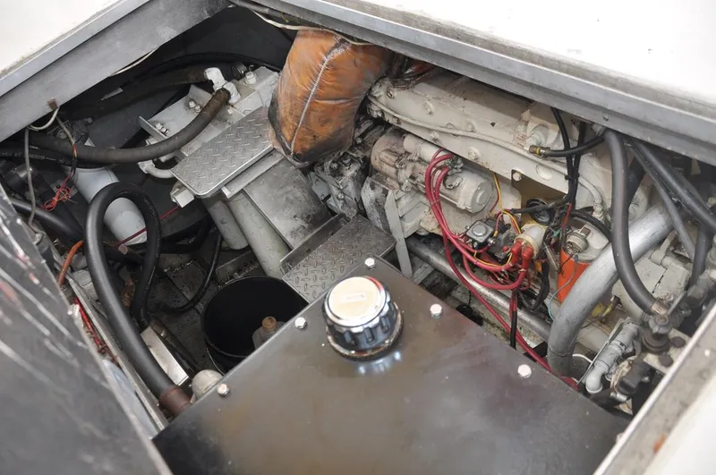 Slide: The Image of Engine compartment of a 1987 Custom Sidewheel Paddle Yacht, showcasing mechanical components and wiring. - 23