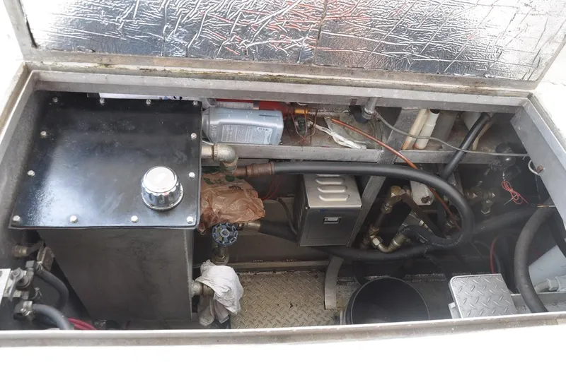 Slide: The Image of Engine compartment of a 1987 custom sidewheel paddle yacht, showcasing mechanical components and wiring. - 24