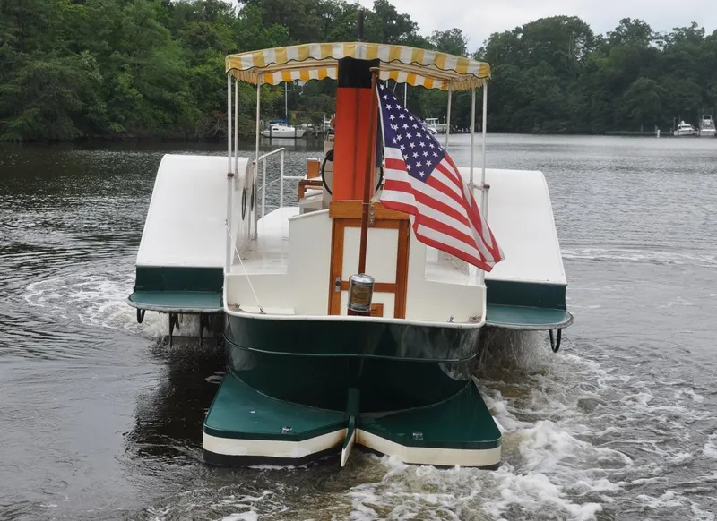 Slide: The Image of Custom 1987 sidewheel paddle yacht with American flag on a serene river. - 3