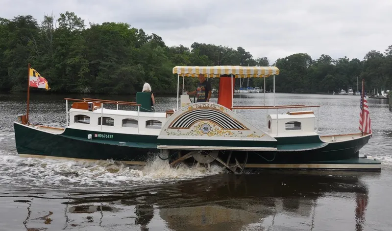 Slide: The Image of Custom 1987 sidewheel paddle yacht cruising on a river with lush green trees. - 5