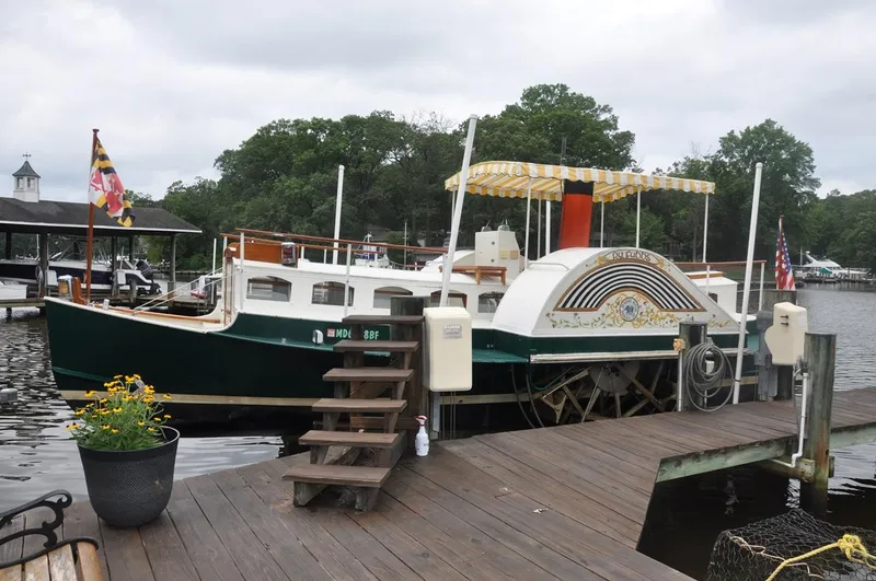 Slide: The Image of Custom 1987 sidewheel paddle yacht docked by a wooden pier, with decorative canopy. - 9