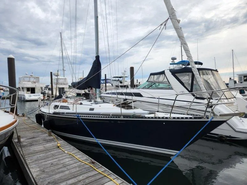 The Image of 1981 C&C 40-2 sailboat docked at marina under cloudy sky. - 0