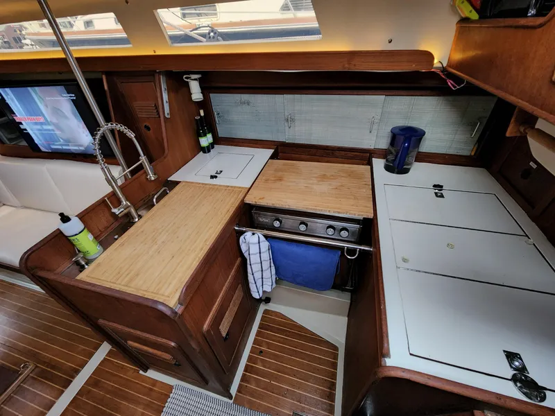 Slide: The Image of 1981 C&C 40-2 yacht kitchen with wood finish, stove, and sink. - 3