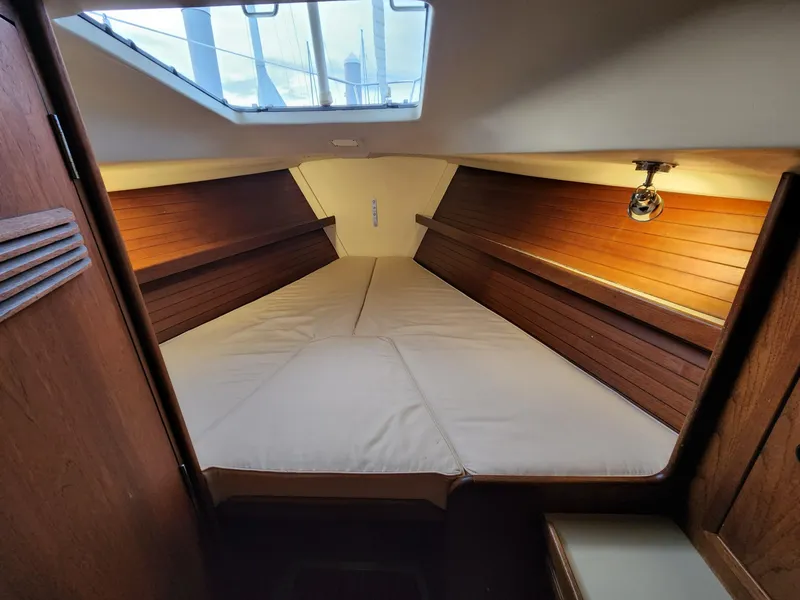 Slide: The Image of Interior cabin of 1981 C&C 40-2 sailboat with cozy V-berth and wooden paneling. - 4