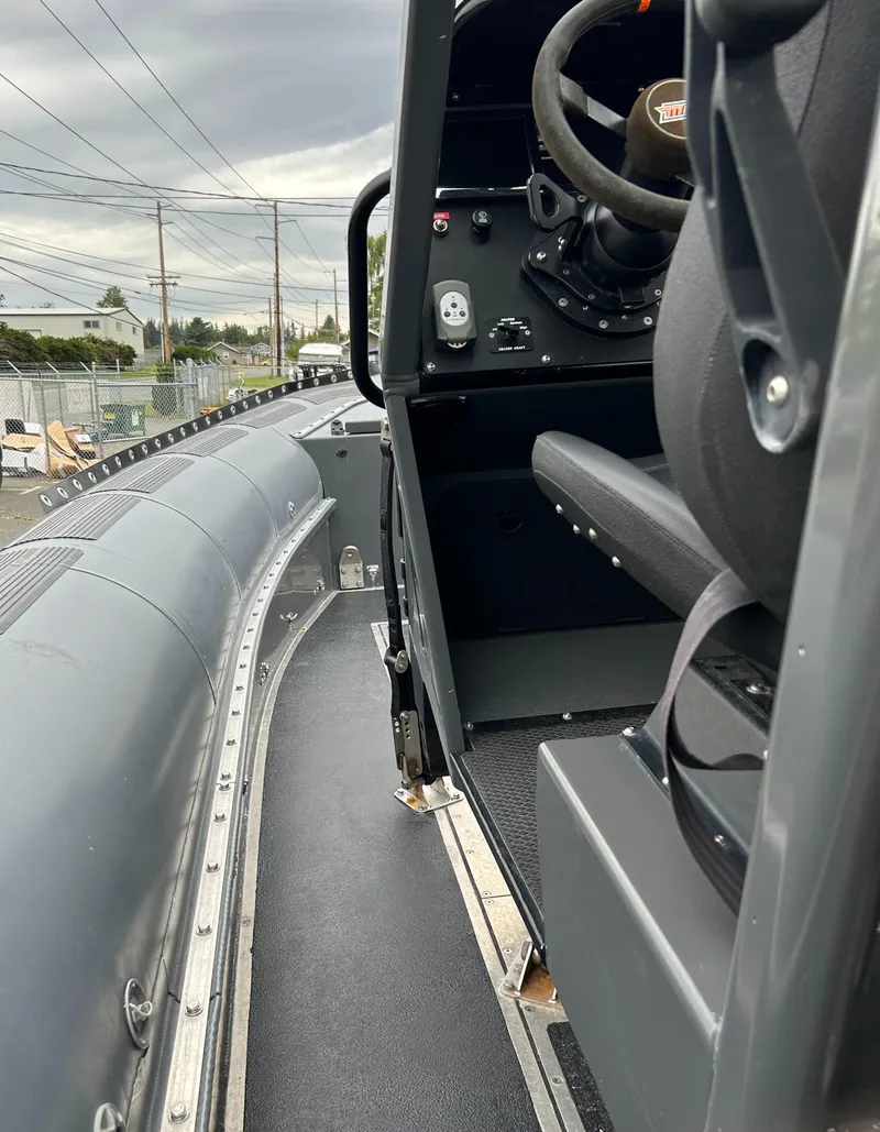 Slide: The Image of 2015 Titan 33 boat interior with steering console and seating. - 11