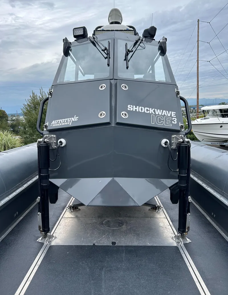 Slide: The Image of 2015 Titan 33 boat with Shockwave ICE3 technology, docked under cloudy skies. - 12