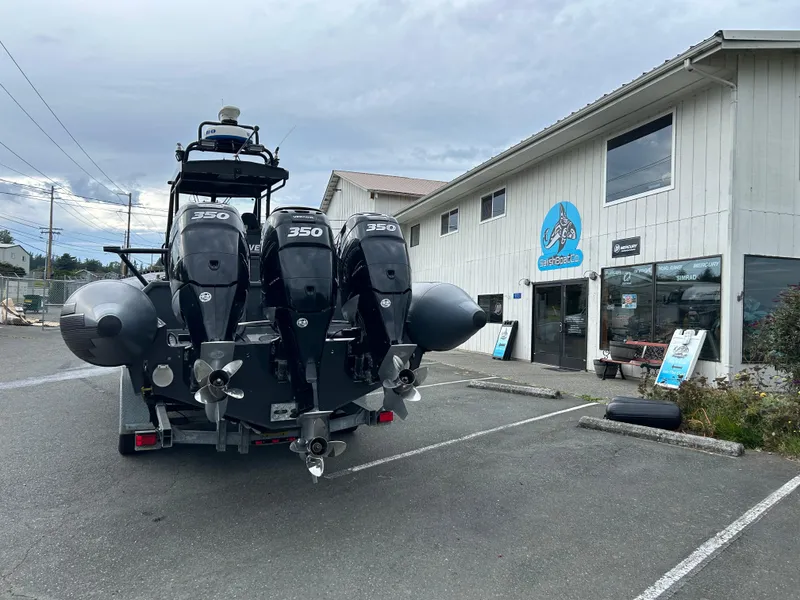 Slide: The Image of Titan 33 boat with triple 350 engines parked outside a marine shop, 2015 model. - 3
