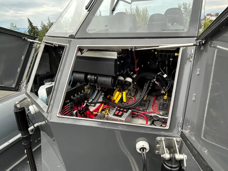 Slide: The Image of Open engine compartment of 2015 Titan 33 boat, showcasing wiring and components. - 6