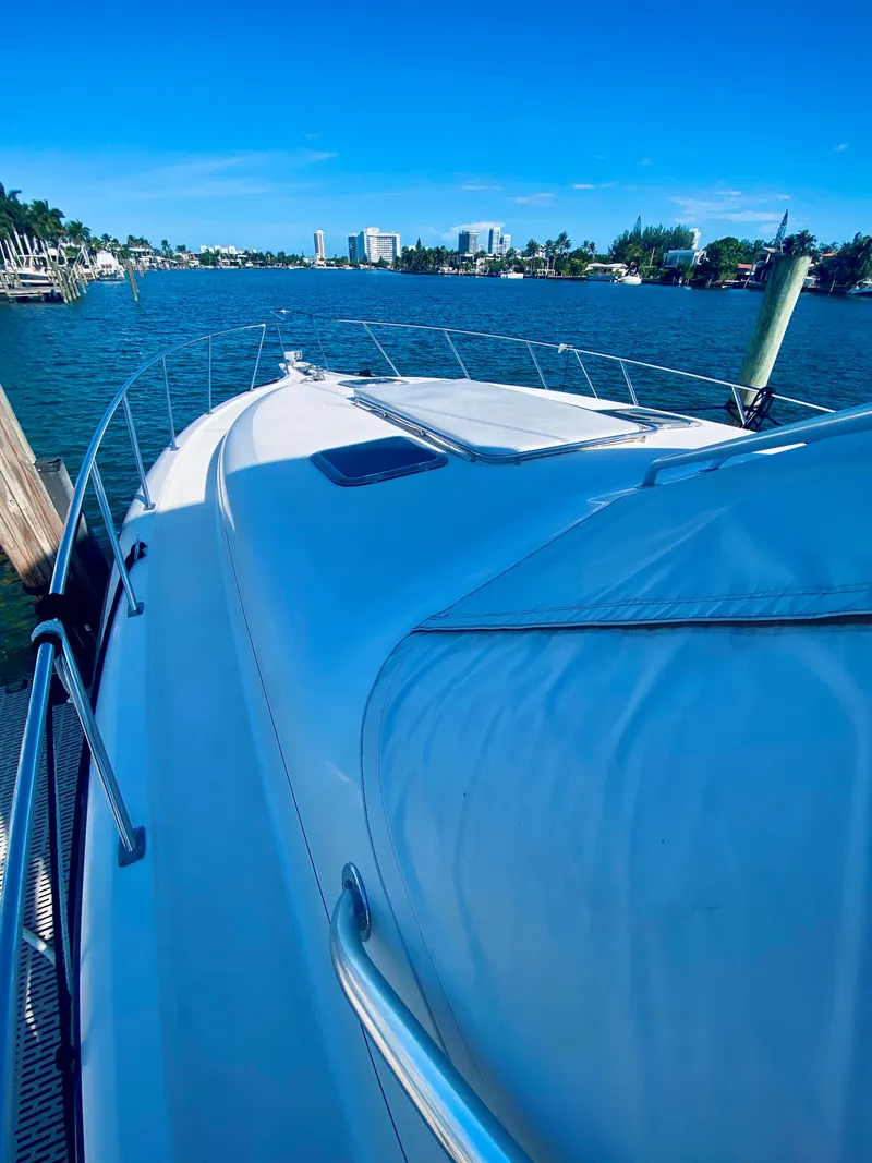 Slide: The Image of 1999 Tiara Yachts 43 Open on calm water, clear sky, coastal view. - 24