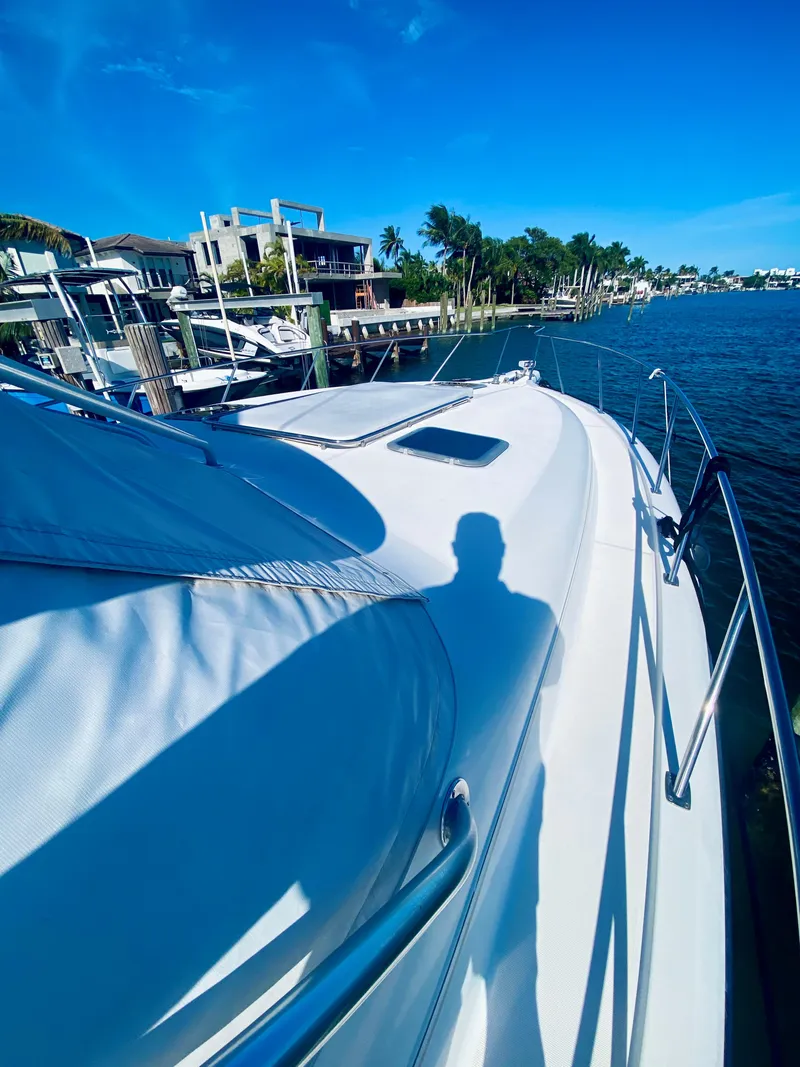 Slide: The Image of 1999 Tiara Yachts 43 Open on a sunny waterfront dock. - 26