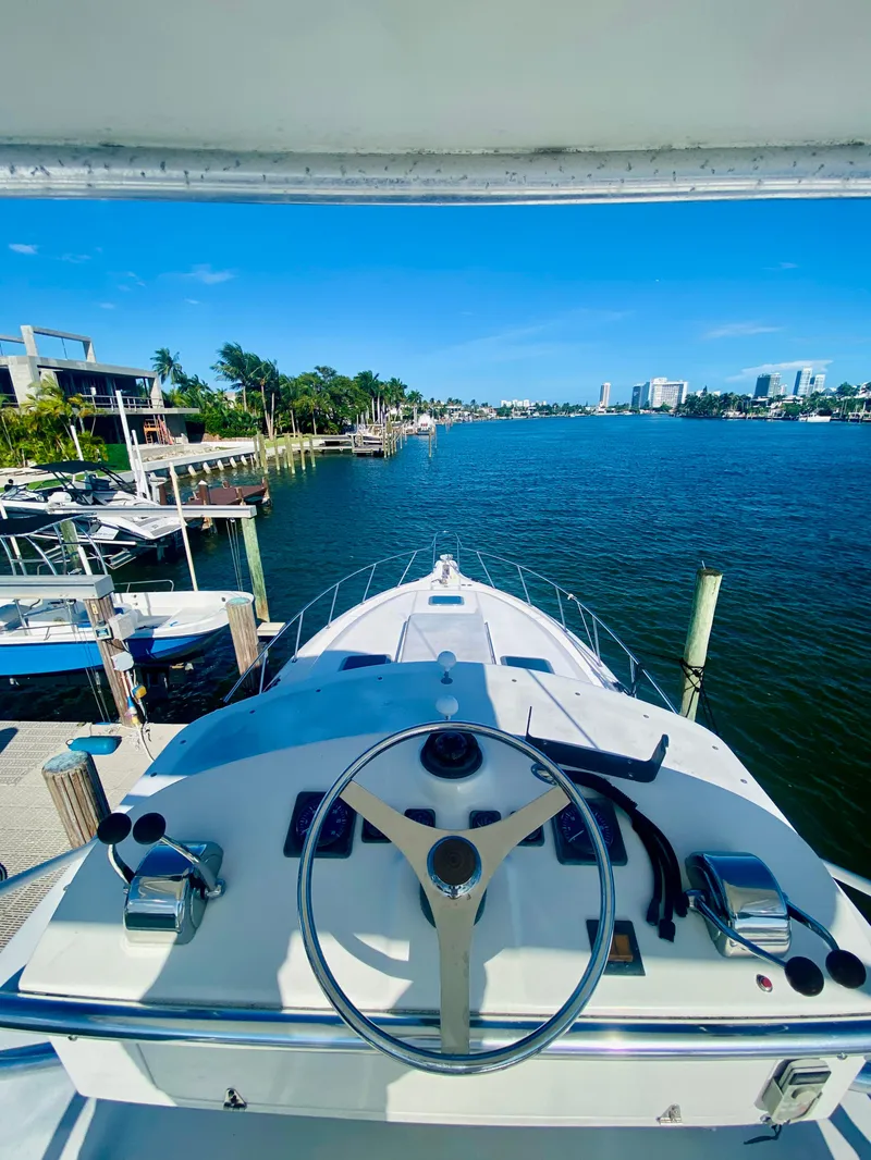 Slide: The Image of 1999 Tiara Yachts 43 Open on a scenic waterfront, clear blue sky. - 29