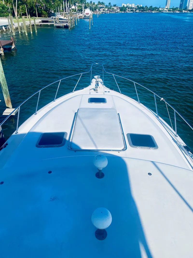 Slide: The Image of 1999 Tiara Yachts 43 Open on calm water, docked at a marina. - 31