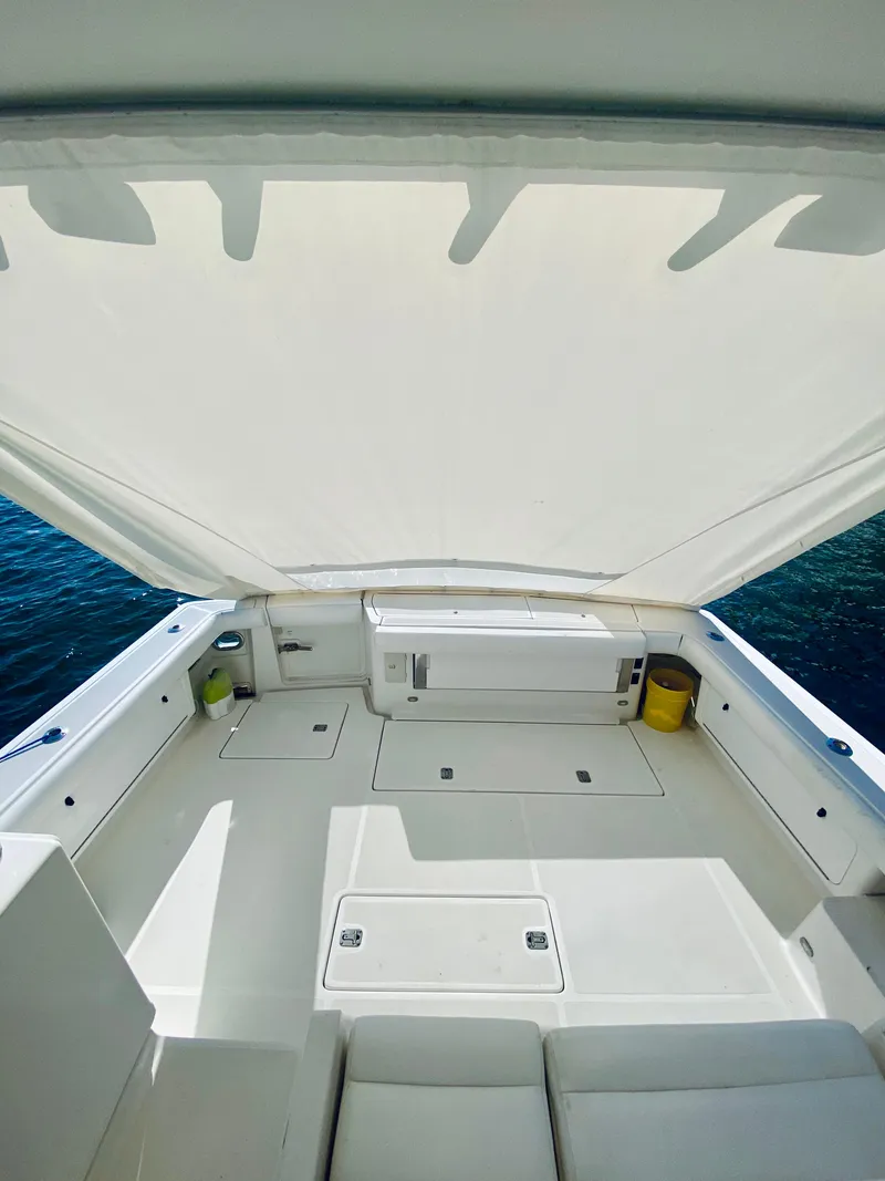 Slide: The Image of 1999 Tiara Yachts 43 Open deck with canopy, overlooking the ocean. - 34