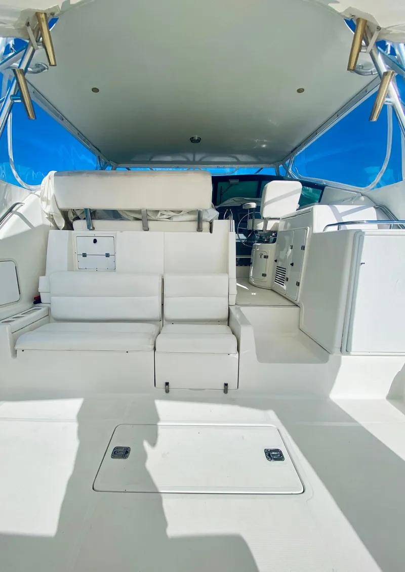Slide: The Image of 1999 Tiara Yachts 43 Open interior with white seating and spacious deck. - 36