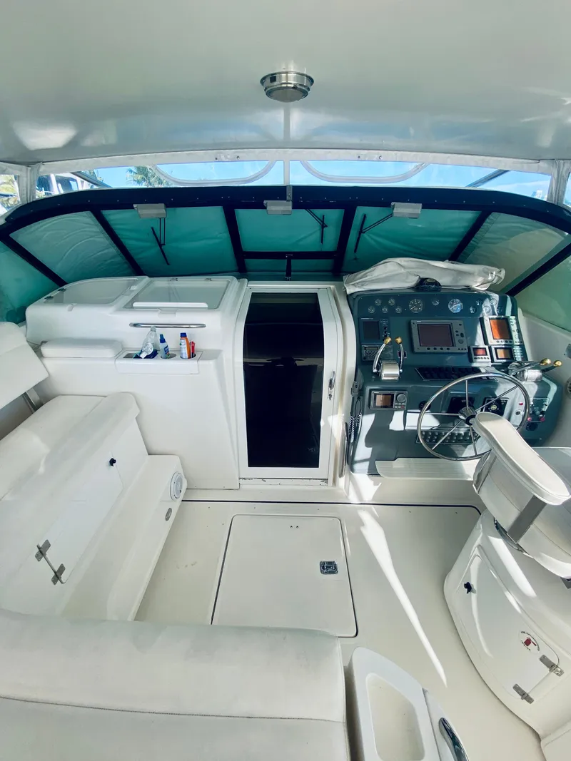 Slide: The Image of 1999 Tiara Yachts 43 Open cockpit with helm, seating, and controls. - 38
