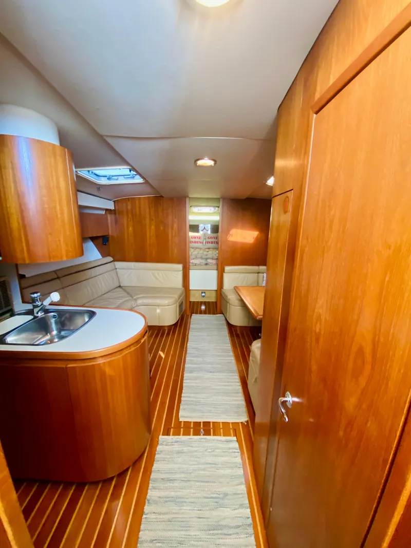 Slide: The Image of Interior of 1999 Tiara Yachts 43 Open with wood finish and modern amenities. - 45