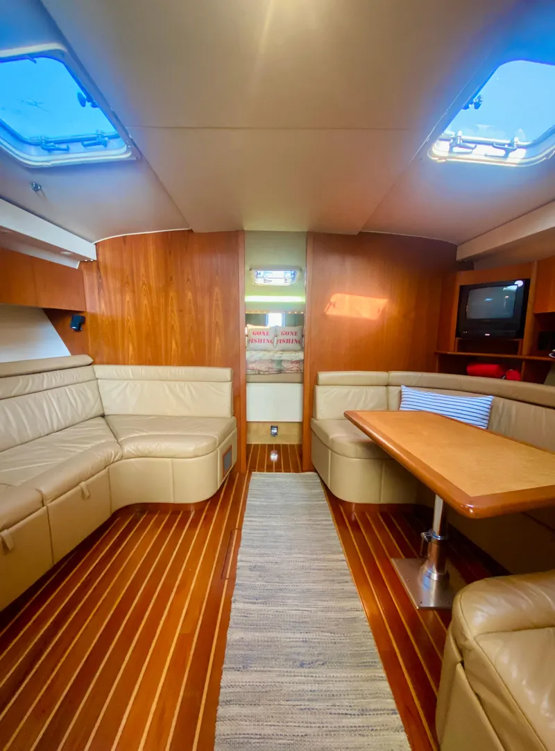 Slide: The Image of Luxurious interior of 1999 Tiara Yachts 43 Open with leather seating and wooden flooring. - 48
