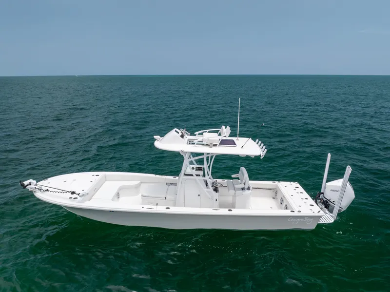 Slide: The Image of 2023 Canyon Bay 28h boat on open sea, side view. - 11