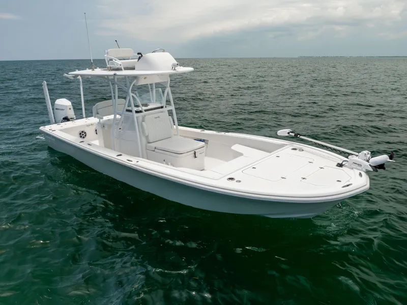 Slide: The Image of 2023 Canyon Bay 28h boat on open water under cloudy sky. - 16