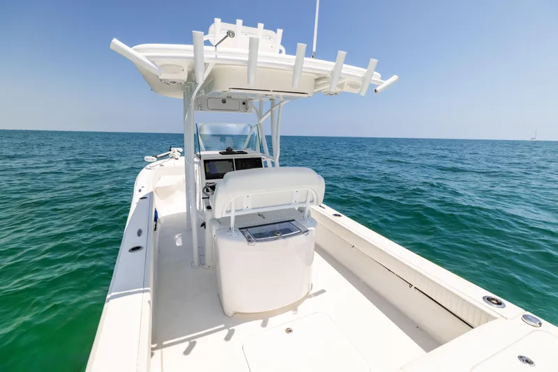Slide: The Image of 2023 Canyon Bay 28h boat on open sea, clear sky, spacious deck. - 23