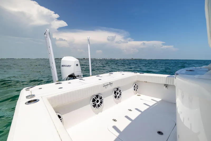 Slide: The Image of 2023 Canyon Bay 28h boat on open water, featuring spacious deck and Mercury engine. - 25