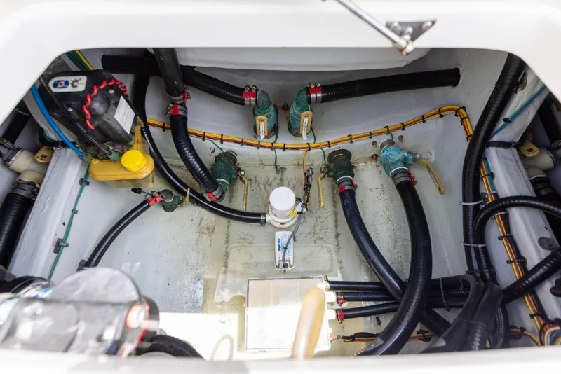 Slide: The Image of Canyon Bay 28h 2023 boat engine compartment with hoses and wiring. - 27