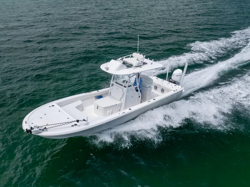 Slide: The Image of 2023 Canyon Bay 28h boat cruising on open water. - 3