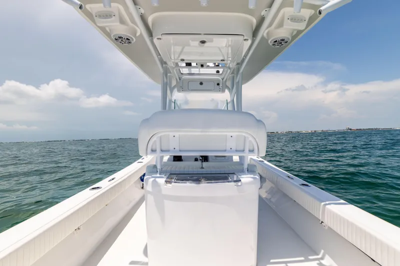 Slide: The Image of Canyon Bay 28h boat, 2023 model, cruising on open water under clear skies. - 32