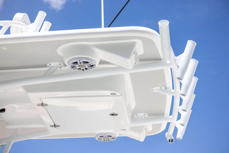 Slide: The Image of 2023 Canyon Bay 28h boat, white structure against blue sky, featuring rod holders and speakers. - 33