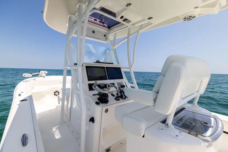 Slide: The Image of 2023 Canyon Bay 28h boat interior with modern helm and ocean view. - 34