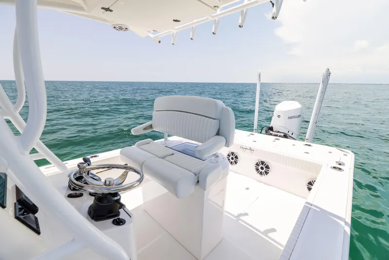 Slide: The Image of 2023 Canyon Bay 28h boat interior with ocean view, featuring helm and seating. - 35