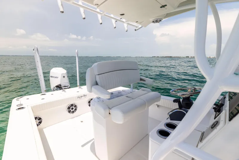 Slide: The Image of 2023 Canyon Bay 28h boat on open water, featuring a sleek helm and seating area. - 36