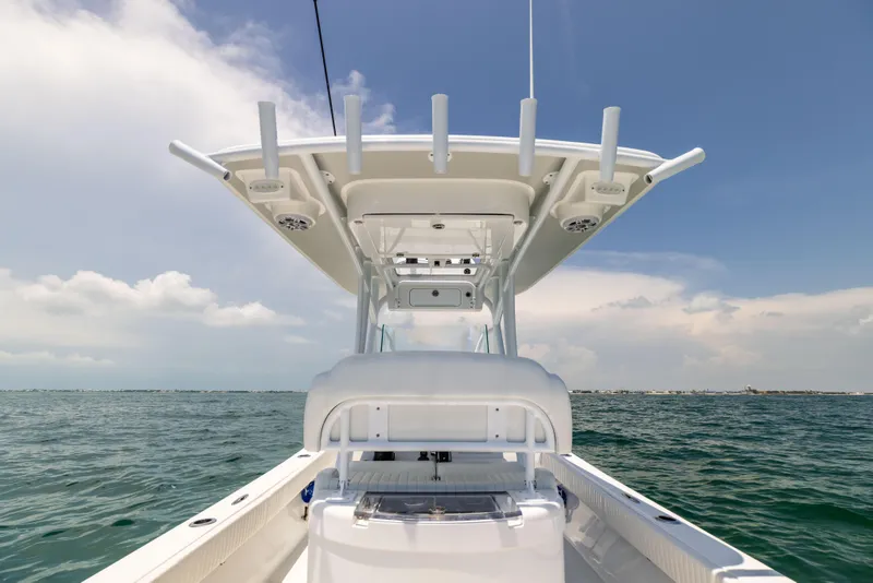 Slide: The Image of 2023 Canyon Bay 28h boat on open water under clear sky. - 37