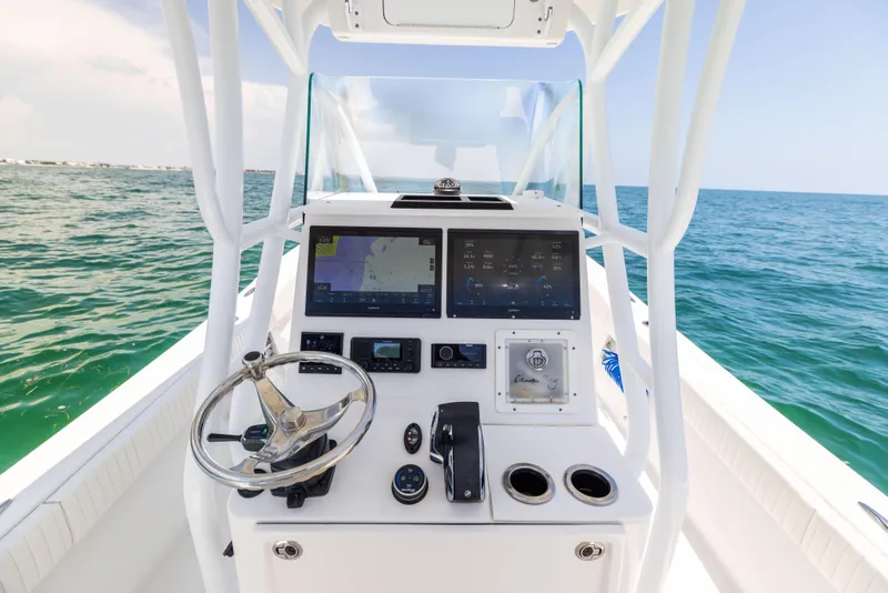 Slide: The Image of 2023 Canyon Bay 28h boat console with navigation screens on open water. - 42