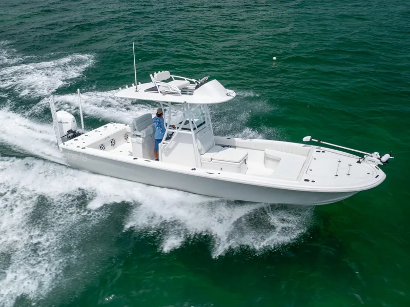 Slide: The Image of 2023 Canyon Bay 28h boat cruising on clear ocean waters. - 7