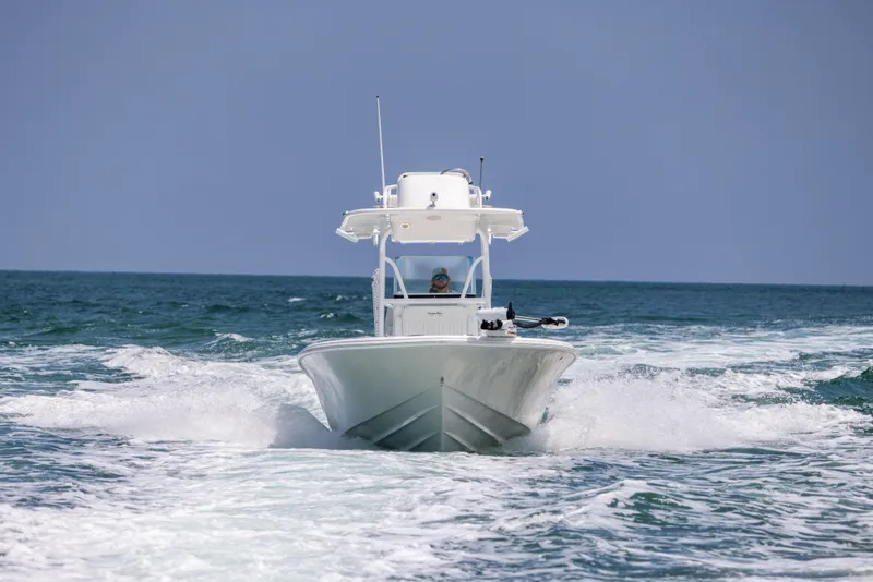 Slide: The Image of 2023 Canyon Bay 28h boat cruising on open ocean waters. - 9